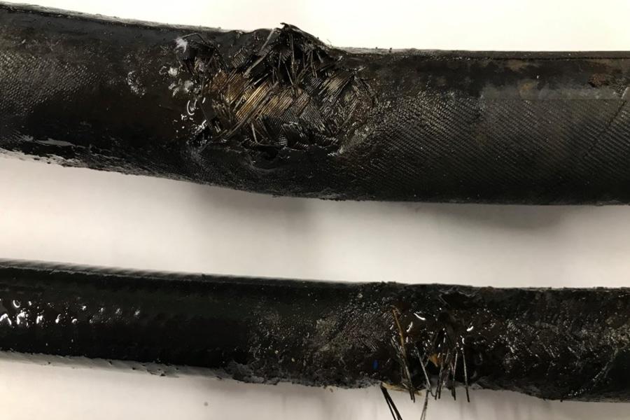 On-site hydraulic hose repair in Sydney with mobile technician fixing burst hose on construction equipment for fast downtime recovery.